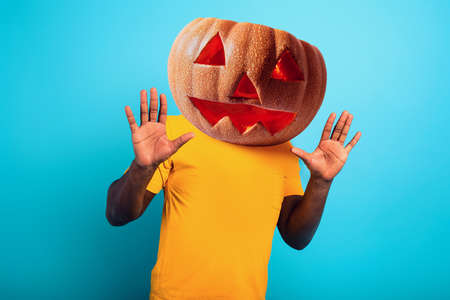 Man with pumpkin instead of head. concept of halloween festivity