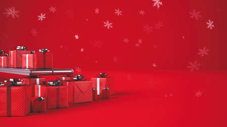 Christmas gift boxes, on conveyor rollers, ready to be shipped on red background with snow flakesの写真素材