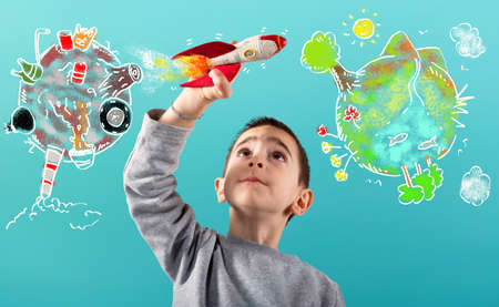 Child with a fast rocket migrates from polluted planet to a clean world. Cyan backgroundの写真素材