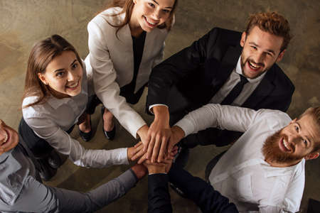 Business people putting their hands together. Concept of teamwork and partnershipの写真素材