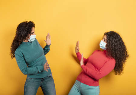Friends stay away to avoid contact and contagion of the virus. Concept of codiv-19 rules to avoid...