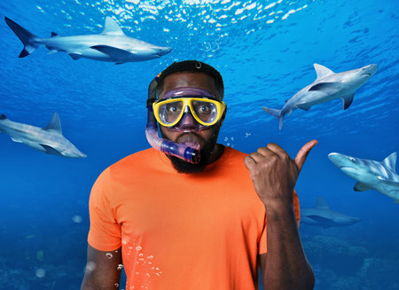 Scared Man with mask underwater surrounded by sharksの写真素材