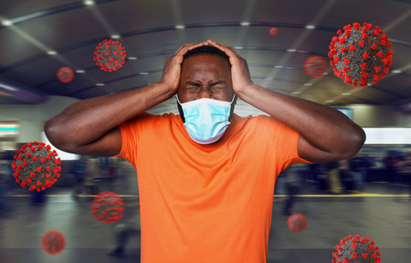Boy with face mask is tired and stressed of covid 19. cyan backgroundの写真素材