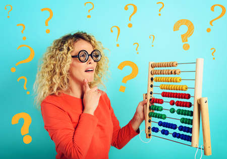 Girl with abacus is confused about the sum . cyan background