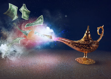 Banknotes exists from magic aladdin genie lamp in a desertの写真素材