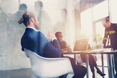 Hipster business man in elegant suit is on business meeting in the office. Double exposure effects