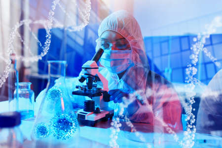 Doctor in the laboratory analyzes samples under a microscope. Pharmaceutical treatment concept.の写真素材