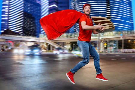 Deliveryman with pizzas acts like a powerful superhero. Concept of success and guarantee on...