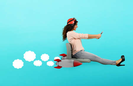 Woman drives fast with rockets under the chair. concept of having the turboの写真素材
