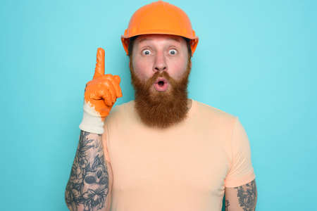 Incompetent worker is wondered about his work. cyan backgroundの写真素材