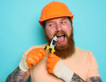 Incompetent worker acts like a dentist and removes a tooth. cyan backgroundの写真素材