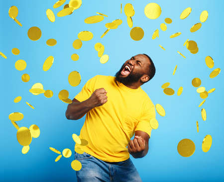 Boy wins money. Amazed and surprised expression face. Light blue background.