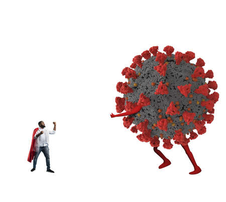 Small medic acts like a superhero to fight pandemic of the big covid19 coronaviruses.の写真素材