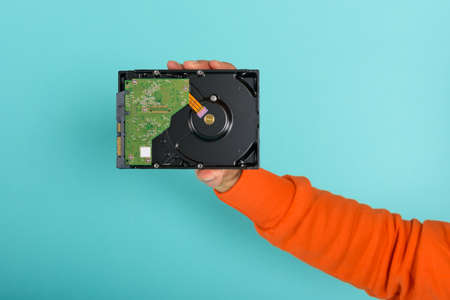 Man holds an hard disk. concept of storage and memory.の写真素材