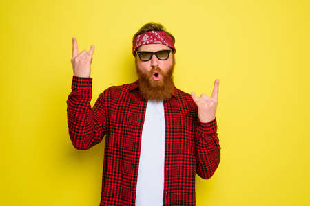 Happy man dances with beard and bandana in headの写真素材