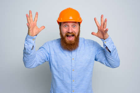 Isolated happy architect with beard and orange helmetの写真素材