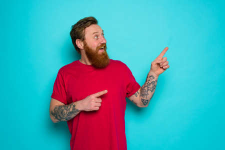 Man is wondered and indicates something with handの写真素材