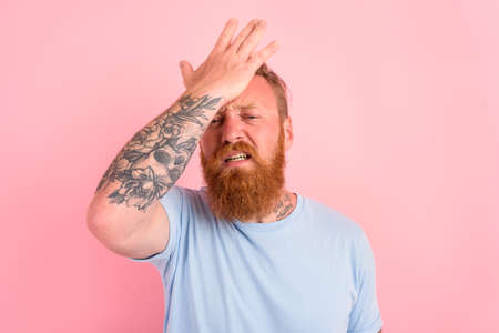 Delusion man with beard and light blue t-shirt