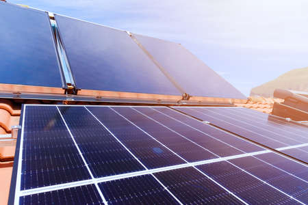 Renewable energy system with solar panel for electricity and hot waterの写真素材