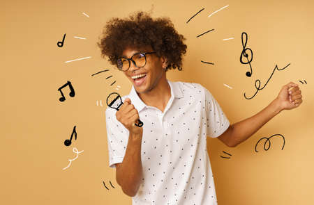 Afro happy man with microphone sing a song