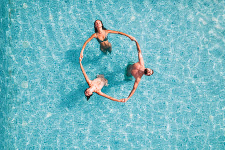 Group of friend play together in a swimming pool