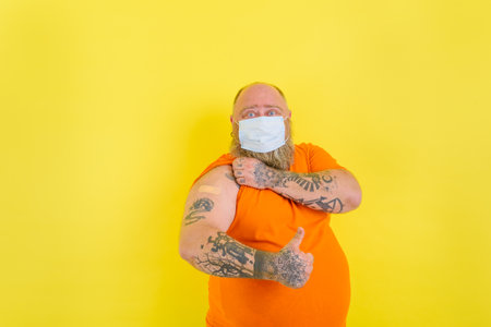 man with beard and tattoos did the vaccine against covid-19の写真素材