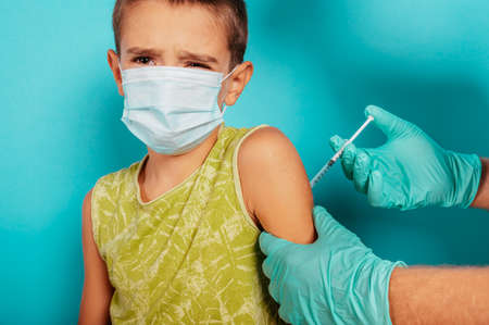Doctor injects vaccine to a child