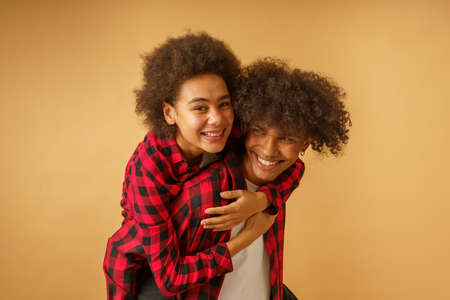 Happy and carefree afro boyfriend and girlfriend play together