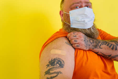 man with beard and tattoos did the vaccine against covid-19の写真素材