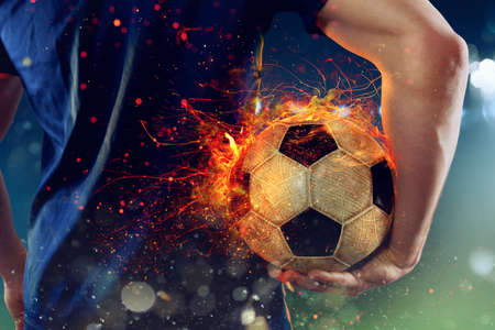 Soccer player ready to play with fiery soccerballの写真素材