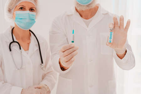 Doctors with face mask are ready to work with the vaccine against the covid-19 virusの写真素材