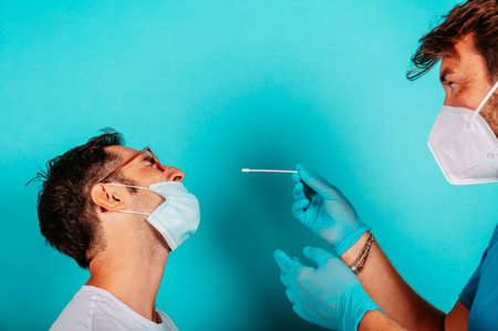 Patient is ready to do a covid-19 test with the doctorの写真素材