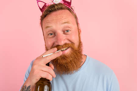 Happy man with beard and tattoos acts like a princess of a taleの写真素材