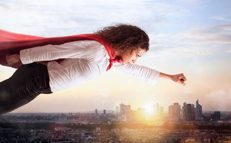 Woman acts like a superhero flying over the city