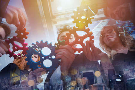 Business team connect pieces of gears as teamwork and partnerの写真素材