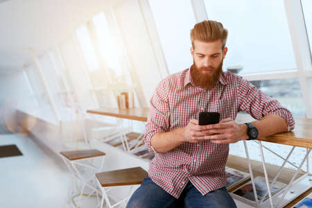 Businessman works in office with a smartphone connected on internet networkの写真素材