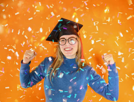 Woman is happy to have achieved graduation and success in studiesの写真素材