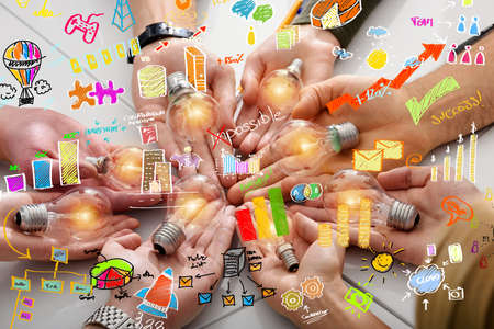 Teamwork and brainstorming concept with businessmen that share an idea with a lampの写真素材