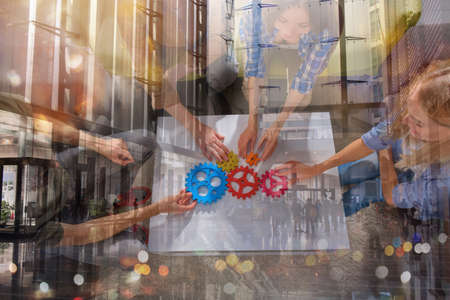Business team connect pieces of gears like a teamwork and partnersの写真素材