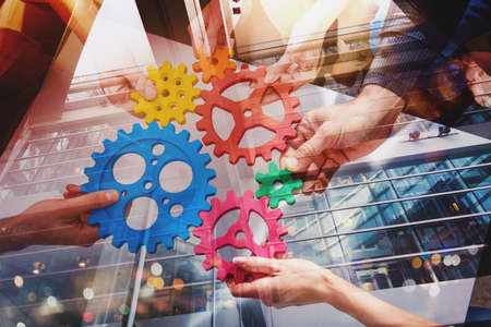 Business team connect pieces of gears like a teamwork and partnersの写真素材