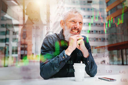 Businessman plays trading stock market and is happyの写真素材