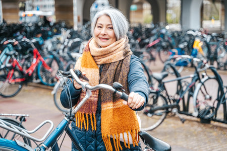Senior woman gets the bike in a parking