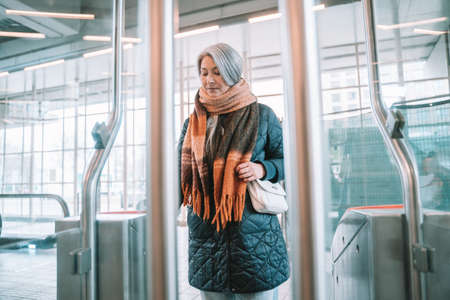 Senior woman enables ticket to takes the train
