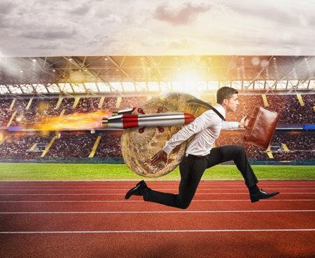 Businessman slow like a snail runs fast thanks to rocketsの写真素材