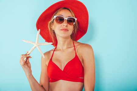 Happy woman ready to the summer with starfish in handの写真素材