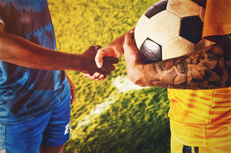 Two opposing players give an handshake at the end of the gameの写真素材