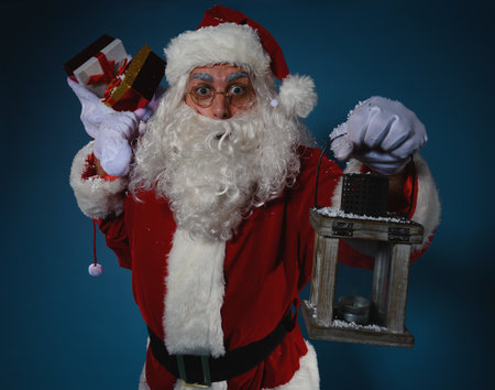 Surprised santa claus with a sack full of giftsの写真素材