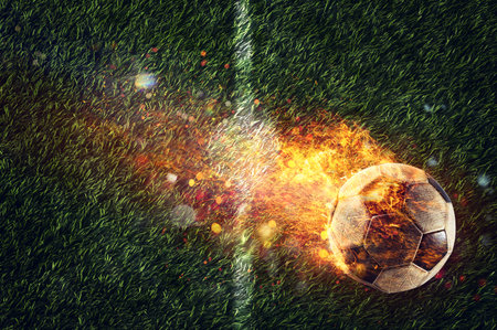 Powerful football kick of a soccer ball with flame of fireの写真素材
