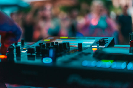 Dj plays disco music with his consolle in a pub