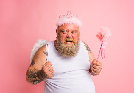 Fat angry man with tattoos acts like a magical fairyの写真素材